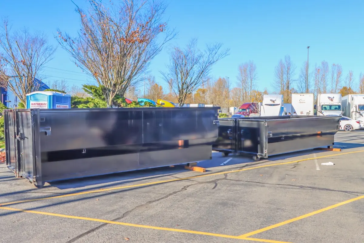 Professional dumpster rental service with roll-off container on residential driveway in Glenwood Springs